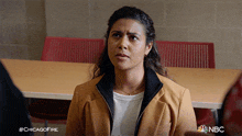 a woman sitting in front of a table with a #chicagofire hashtag
