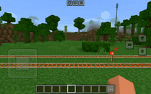 a screenshot of a minecraft game shows a train track and trees in the background