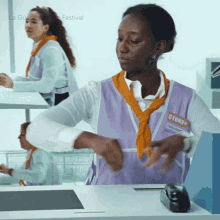 a woman wearing a purple vest with a name tag that says store +