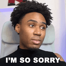 a man sitting in a chair with the words i 'm so sorry on the bottom