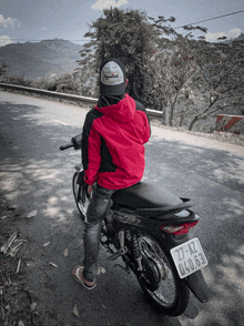 a person sitting on a motorcycle with a license plate that says 27-kz 04.63