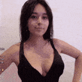a woman in a black bra is standing in front of a white wall with the words light written on her arm