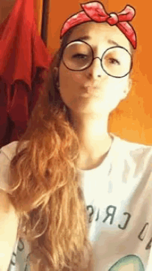 a woman wearing glasses and a headband with a bow on it