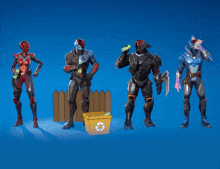 four robots are standing next to each other with a recycling bin