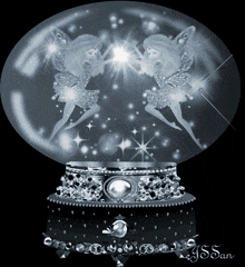 a snow globe with two fairies inside of it and the name j.s. san on the bottom
