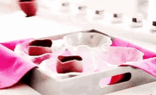 a tray with a pink napkin and a few bowls on it