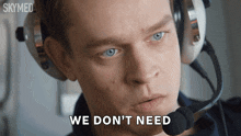 a man with headphones and a microphone says we don 't need