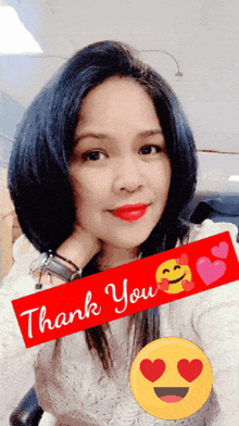 a woman taking a selfie with a thank you sticker