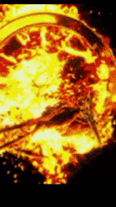 a close up of a fire with a helicopter flying through it