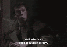 a man smoking a cigarette with the words well what 's so good about democracy