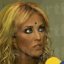 a close up of a woman 's face with a star on her forehead that says rbd gif