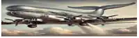 a silver airplane is flying through the clouds with the number 29 on the tail