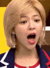 a close up of a woman 's face with her mouth wide open