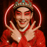 a man in a red costume is making a peace sign with his fingers