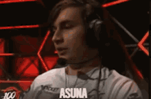a man wearing headphones with the word asuna written on his shirt