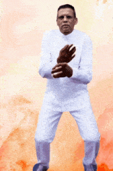 a man in a white shirt and white pants is standing in a karate pose