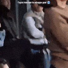 a group of people are standing in a room with the words fayza reaction to mbappe goal on the bottom