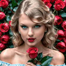 a woman with blue eyes holds a red rose in front of a wall of red roses