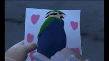 a person is holding a piece of paper with hearts on it and a picture of luigi on it