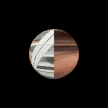 a half white and half brown sphere on a black background .