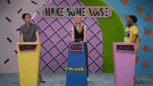 a group of people standing in front of a sign that says make some noise