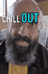 a man with a beard wearing glasses and a yellow shirt says chill out