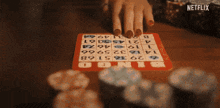 a person playing a game of bingo with a netflix logo in the corner