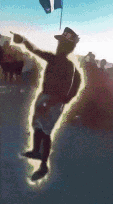 a man in a cowboy hat is standing in front of a flag