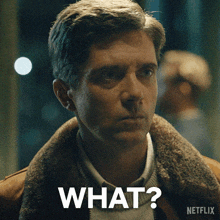a man with a fur collar is asking the question what