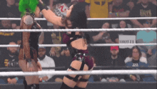two women are wrestling in a ring with a sign in the background that says shot 21