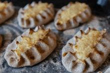 a bunch of pastries are on a table with powdered sugar on them