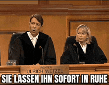 a man and a woman are sitting at a judge 's bench .