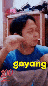 a man in a blue shirt with the word goyang written on it