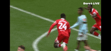 a soccer player in a red jersey with the number 24 on it
