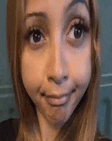 a close up of a woman 's face with a funny face .