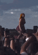 a woman with red hair is dancing in front of a crowd at a concert .