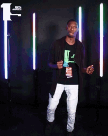a man stands in front of a bet awards logo