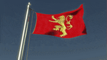 a red flag with a gold lion on it is waving in the wind