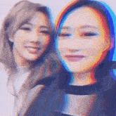 two women are posing for a picture together with a rainbow in the background .