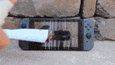 a nintendo switch with a cigarette on the screen