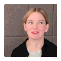 a close up of a woman 's face with her eyes closed and a smile on her face .