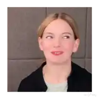 a close up of a woman 's face with her eyes closed and a smile on her face .