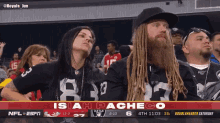 a man with dreadlocks is watching a football game with the name isiah pacheco at the top