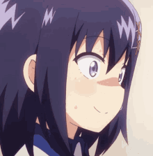 a close up of a girl 's face with a w on her head