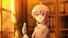 a girl with pink hair holds a remote control in her hand