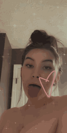 a woman sticking her tongue out with a pink heart behind her