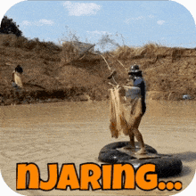 a man is standing on a raft in a river with the word njaring written on the bottom