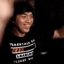 a man wearing a black shirt that says mentally loaded please wait