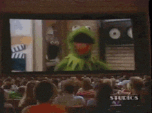 a crowd of people are watching a disney studios cartoon