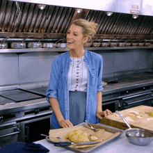 a woman in a kitchen with a sign on the wall that says captain 's choice